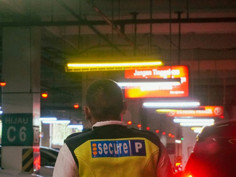 Parking enforcement officer patrolling Ontario commercial lot